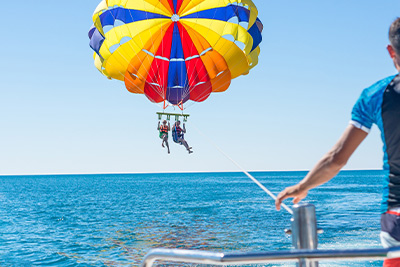 Couple parasailing off a boat